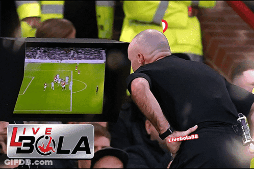 Man Standing In Front Of Live Bola Screen GIF