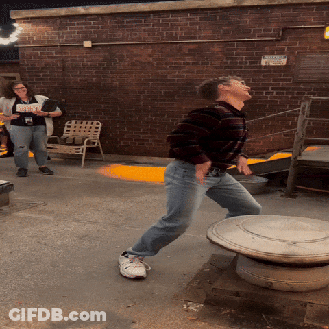 Man Standing In Front Of No Parking Sign On Brick Wall GIF