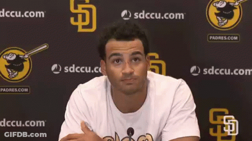 Man Standing In Front Of Padres.com Wall GIF