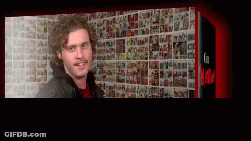 Man Standing In Front Of Picture Wall GIF