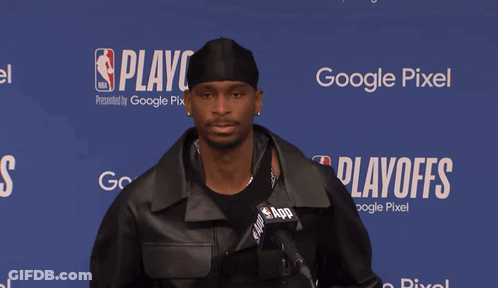 Man Standing In Front Of Playoff Sign GIF