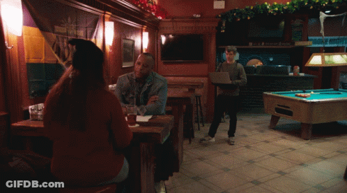 Man Standing In Front Of Pool Table With Menu GIF