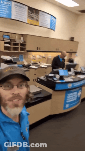 Man Standing In Front Of Priority Mail Sign GIF
