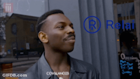 Man Standing In Front Of Relat Sign GIF
