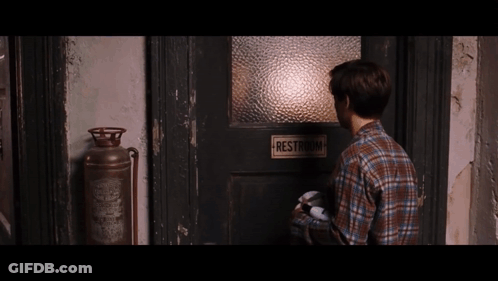 Man Standing In Front Of Restroom Door GIF