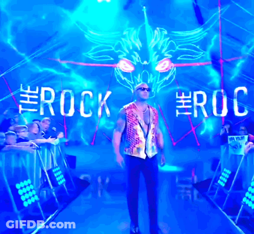 Man Standing In Front Of Rock Sign GIF
