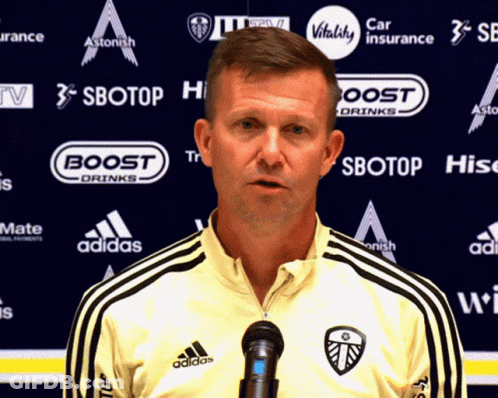 Man Standing In Front Of Sbotop Sign GIF