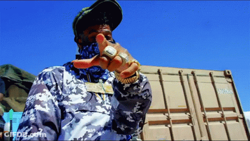 Man Standing In Front Of Shipping Container Number 57000 GIF