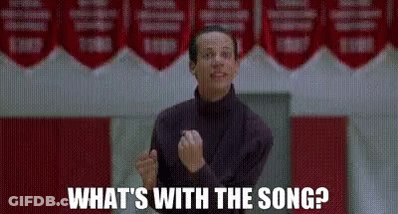 Man Standing In Front Of Sign What's With The Song GIF