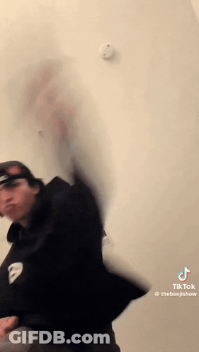 Man Standing In Front Of Smoke Detector GIF
