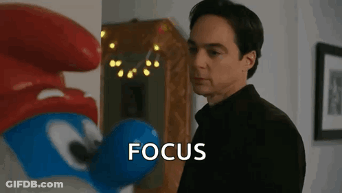 Man Standing In Front Of Smurf Saying Focus GIF
