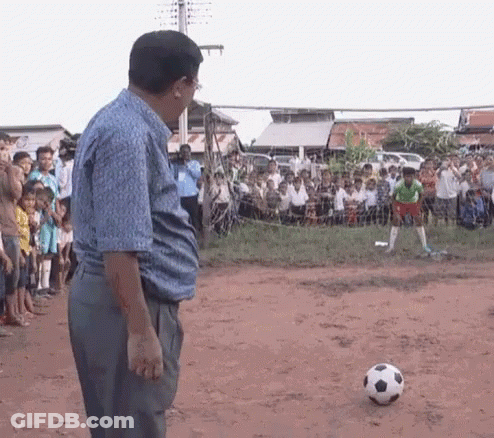 Man Standing In Front Of Soccer Ball GIF