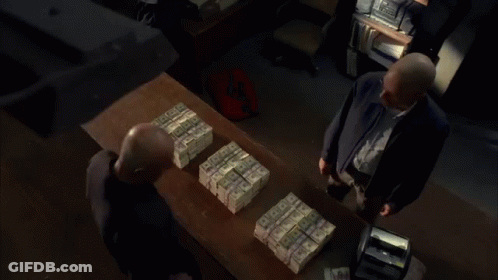 Man Standing In Front Of Stack Of Money GIF