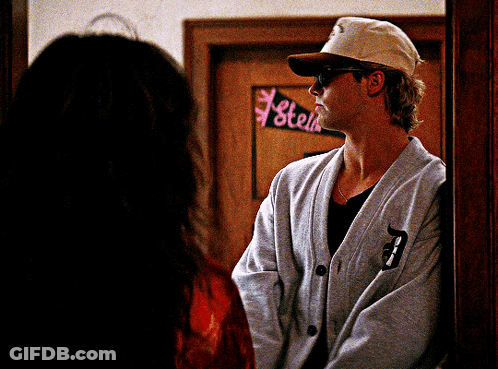Man Standing In Front Of Stell Sign GIF