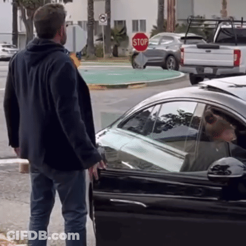 Man Standing In Front Of Stop Sign Next To Car GIF
