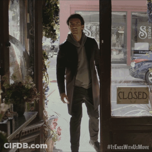 Man Standing In Front Of Store With Closed Sign GIF