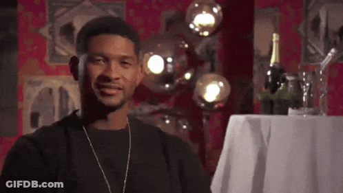 Man Standing In Front Of Table With Wine Bottle GIF