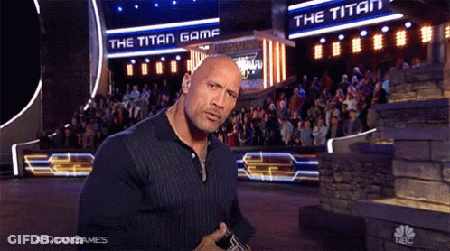 Man Standing In Front Of Titan Game Sign GIF