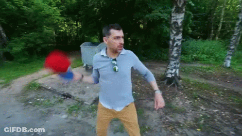Man Standing In Front Of Trash Can In Woods GIF