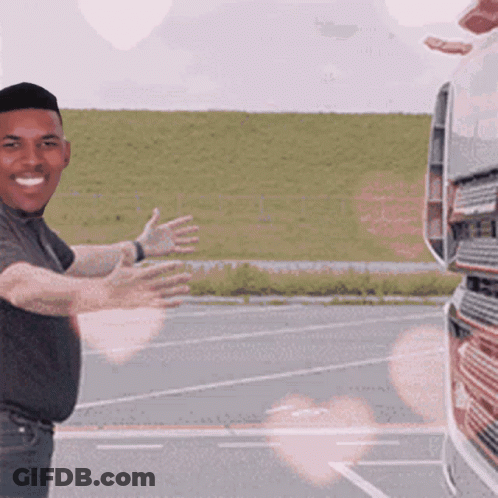 Man Standing In Front Of Truck With Arms Outstretched Smiling GIF