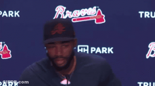 Man Standing In Front Of Trust HH Park Sign GIF