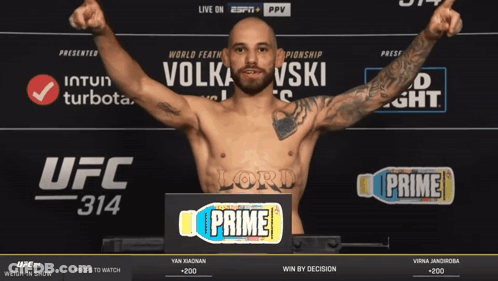 Man Standing In Front Of UFC 314 Sign GIF