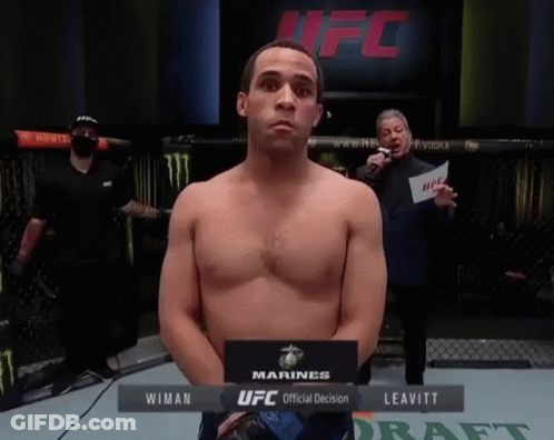 Man Standing In Front Of UFC Official Decision Sign GIF