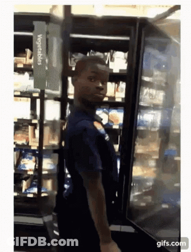 Man Standing In Front Of Vegetables Refrigerator GIF