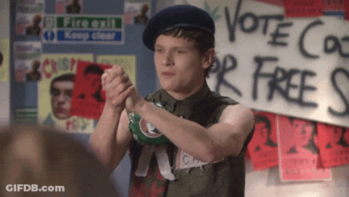 Man Standing In Front Of Vote Co For Free Sign GIF