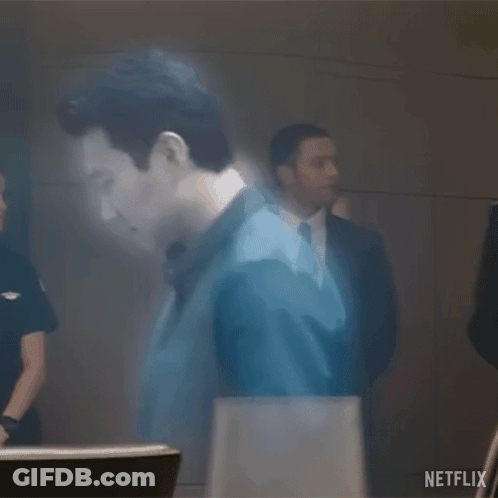 Man Standing In Front Of Wall With Ghostly Image GIF