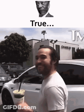 Man Standing In Front Of White Car Holding Coffee GIF