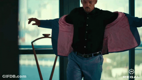 Man Standing In Front Of Window With Regal Logo GIF