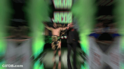 Man Standing In Front Of Wood Jacob Sign GIF