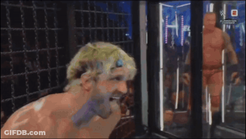 Man Standing In Front Of WWE Sign GIF