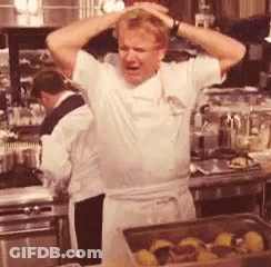 Man Standing In Kitchen With Hands On Head GIF