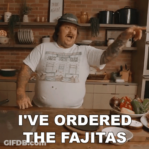 Man Standing In Kitchen With Words I've Ordered The Fajitas GIF