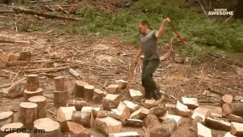 Man Standing In Log Pile With Axe And Awesome Sign GIF