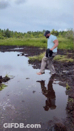 Man Standing In Puddle With Reflection GIF