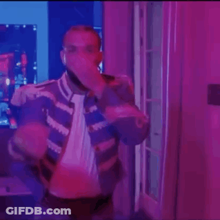 Man Standing In Purple Lit Room With Microphone GIF