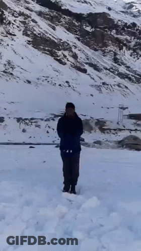 Man Standing In Snow Holding Shovel GIF