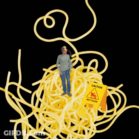 Man Standing In Spaghetti With Wet Floor Sign GIF
