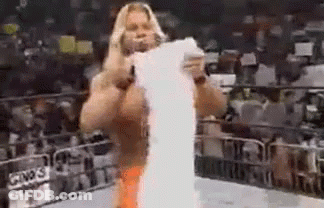 Man Standing In Wrestling Ring Holding Paper GIF