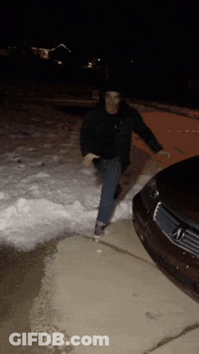 Man Standing Next To Car In Snow At Night GIF
