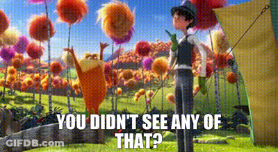 Man Standing Next To Cartoon Character In Flower Field GIF