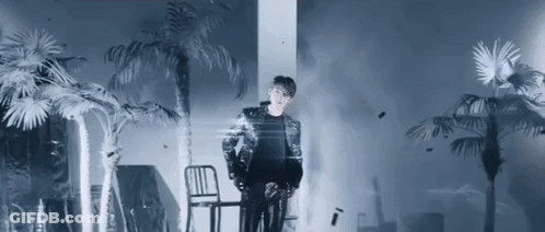 Man Standing Next To Chair With Palm Trees GIF