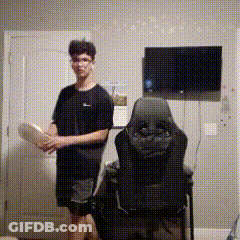 Man Standing Next To Chair With TV GIF