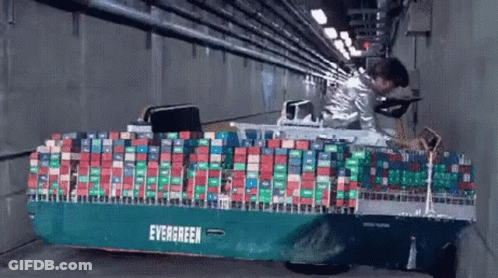 Man Standing Next To Container Ship In Tunnel GIF
