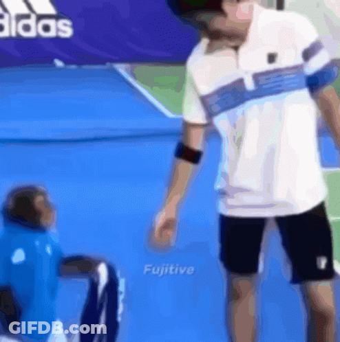 Man Standing Next To Monkey On Tennis Court GIF
