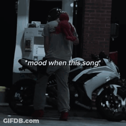 Man Standing Next To Motorcycle With Mood When This Song GIF