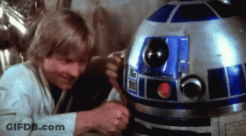Man Standing Next To R2D2 Robot GIF